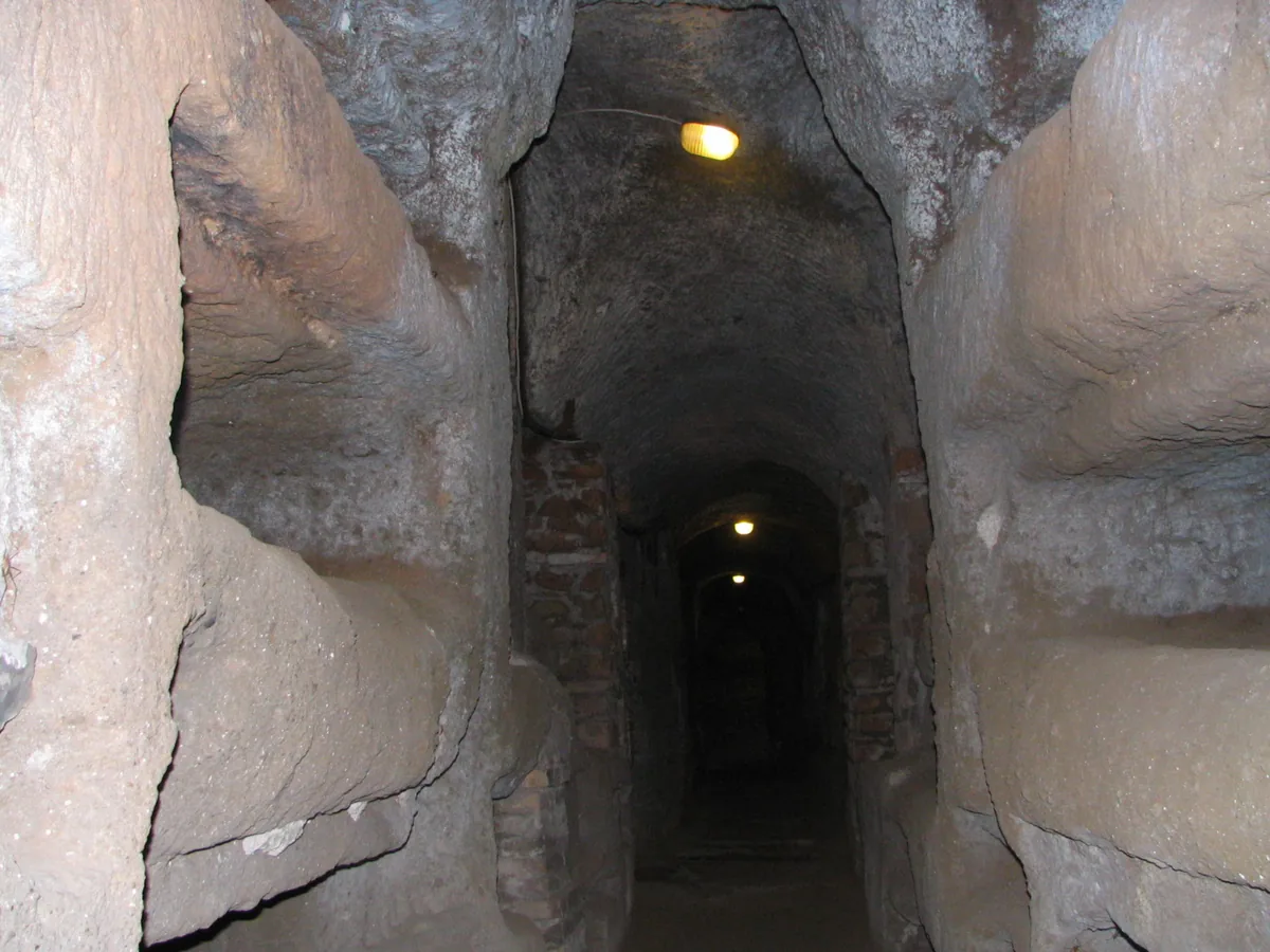 A gallery lined with loculi in the Catacombs of St Callixtus, Rome